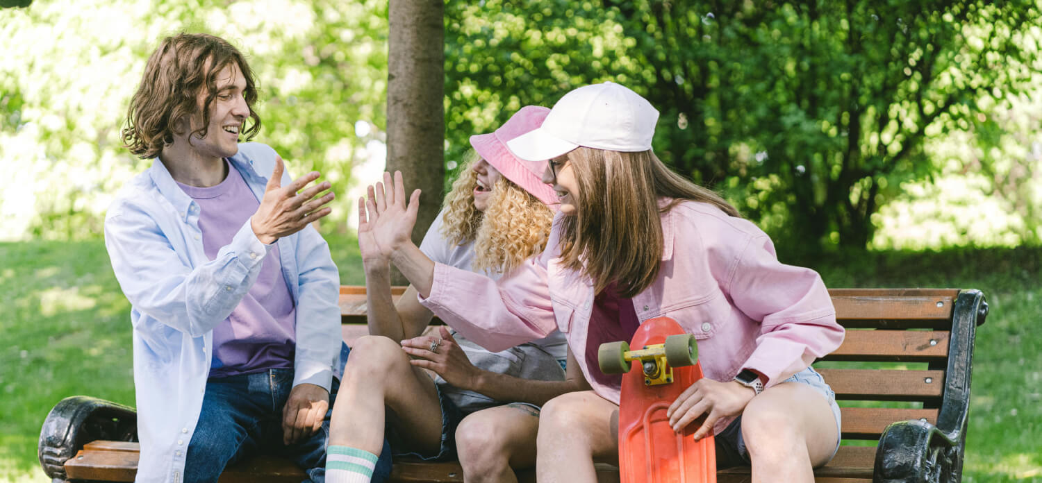 Teens hanging out on park bench